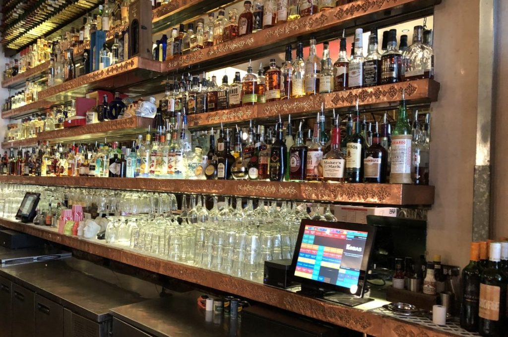 Wide angle shot of a very well stocked bar and two Kobas tills